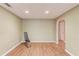 Finished basement area with exercise equipment and archway to unfinished area at 1446 Chadwick Ridge Ct, Lawrenceville, GA 30043