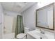 Bathroom with a shower and tub, features modern fixtures, a decorative mirror and neutral color palette at 1446 Chadwick Ridge Ct, Lawrenceville, GA 30043