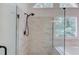 Glass enclosed shower with rainfall shower head and marble wall tile at 1446 Chadwick Ridge Ct, Lawrenceville, GA 30043