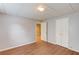 Finished room has hardwood flooring, light gray walls, and offers a closet and access to another room at 1446 Chadwick Ridge Ct, Lawrenceville, GA 30043