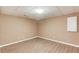 The finished room has hardwood flooring and beige walls, featuring a wall cabinet for storage at 1446 Chadwick Ridge Ct, Lawrenceville, GA 30043