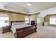 Spacious bedroom with tray ceiling, bedside tables, and a large window with natural light at 1446 Chadwick Ridge Ct, Lawrenceville, GA 30043