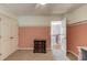 Comfortable bedroom with pink accent wall, closet and view to the stairway landing at 1446 Chadwick Ridge Ct, Lawrenceville, GA 30043