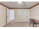 A cozy carpeted bedroom offers a ceiling fan, and open doorway with a desk and chair for versatile living at 1446 Chadwick Ridge Ct, Lawrenceville, GA 30043