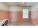 Bedroom boasting a pink accent wall, plush carpeting and ample natural light at 1446 Chadwick Ridge Ct, Lawrenceville, GA 30043