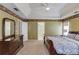 Large bedroom with floral wallpaper border, hardwood furniture, and a door to the bathroom at 1446 Chadwick Ridge Ct, Lawrenceville, GA 30043