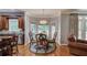 Bright breakfast nook with a round table, chairs, and large windows overlooking the backyard at 1446 Chadwick Ridge Ct, Lawrenceville, GA 30043