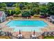 Large community swimming pool with plenty of lounge chairs and umbrellas for a relaxing day at 1446 Chadwick Ridge Ct, Lawrenceville, GA 30043