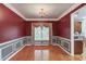 Formal dining room featuring hardwood floors, elegant chandelier, and beautiful wainscoting at 1446 Chadwick Ridge Ct, Lawrenceville, GA 30043
