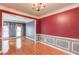 Open-concept view of the living and dining rooms featuring hardwood floors and elegant details at 1446 Chadwick Ridge Ct, Lawrenceville, GA 30043