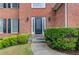 Close-up of the front door framed by manicured bushes and classic brick architecture at 1446 Chadwick Ridge Ct, Lawrenceville, GA 30043