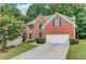 Charming brick two-story home with well-manicured lawn and a two-car garage at 1446 Chadwick Ridge Ct, Lawrenceville, GA 30043