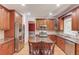 Kitchen with granite countertops, stainless steel appliances, and custom wood cabinetry at 1446 Chadwick Ridge Ct, Lawrenceville, GA 30043