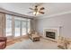 Bright living room with hardwood floors, fireplace, and French doors leading to the deck at 1446 Chadwick Ridge Ct, Lawrenceville, GA 30043