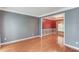 Spacious living room with hardwood floors, crown molding, and fresh, gray paint at 1446 Chadwick Ridge Ct, Lawrenceville, GA 30043