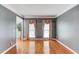 Bright living room showcasing hardwood floors, neutral paint, and elegant window treatments at 1446 Chadwick Ridge Ct, Lawrenceville, GA 30043