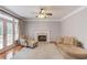 Cozy living room features a fireplace, hardwood floors, and a comfortable seating arrangement at 1446 Chadwick Ridge Ct, Lawrenceville, GA 30043