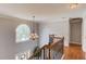 Elegant staircase with hardwood steps, wrought iron railing, and arched window at 1446 Chadwick Ridge Ct, Lawrenceville, GA 30043