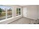 Bedroom featuring carpet, large windows with beautiful backyard views, and a white door at 6219 Heardsville Rd, Cumming, GA 30028