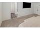 Carpeted bedroom with bed, storage bench and flat screen television at 198 Colbury St, Villa Rica, GA 30180