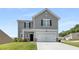 Charming two-story home features gray siding, black shutters, and a well-maintained front yard at 198 Colbury St, Villa Rica, GA 30180