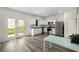 White kitchen features stainless steel appliances and a view of the backyard through the double doors at 198 Colbury St, Villa Rica, GA 30180
