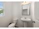 Bright powder room with a pedestal sink, modern fixtures, and a window for natural light at 198 Colbury St, Villa Rica, GA 30180
