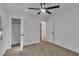 Well-lit bedroom featuring a modern ceiling fan, neutral carpet, and access to a closet and hallway at 2358 Tilson Rd, Decatur, GA 30032