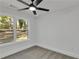 Bedroom with a ceiling fan and a window that displays views of the lush greenery surrounding the property at 2358 Tilson Rd, Decatur, GA 30032