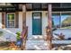 Newly painted teal front door with glass, updated hardware and charming wood railing at 2358 Tilson Rd, Decatur, GA 30032