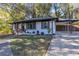 Charming renovated home with freshly painted brick exterior, lush lawn, and a carport at 2358 Tilson Rd, Decatur, GA 30032