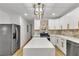 Modern kitchen with a spacious island, stainless steel appliances, and sleek white cabinets at 2358 Tilson Rd, Decatur, GA 30032