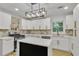 Bright kitchen featuring white cabinets, stainless steel appliances, island, and quartz countertops at 2358 Tilson Rd, Decatur, GA 30032
