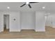 Living room boasting freshly painted white walls, hardwood floors, and modern ceiling fan at 2358 Tilson Rd, Decatur, GA 30032