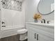 Well-lit bathroom featuring a modern vanity, tub-shower, and eye-catching decorative tile at 490 Third Ave, Scottdale, GA 30079