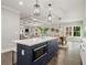 Open concept kitchen with a center island overlooking the dining area and living room, perfect for entertaining at 490 Third Ave, Scottdale, GA 30079