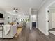 Open-concept floor plan with light gray walls, coffered ceiling, and dark wood flooring, flowing through the house at 490 Third Ave, Scottdale, GA 30079