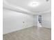 An expansive finished basement features gray wood-look tile flooring and access to a bathroom at 1153 Dawn View Ne Ln, Atlanta, GA 30327