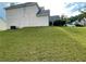 View of a large grassy backyard with neighboring houses and ample space for recreation at 15 Emerson Trl, Covington, GA 30016