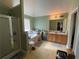Bright bathroom featuring a shower, soaking tub, double sink vanity, and a textured ceiling at 15 Emerson Trl, Covington, GA 30016