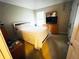Cozy bedroom with a white bed frame, dresser with TV, neutral walls and carpet at 15 Emerson Trl, Covington, GA 30016