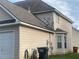 Exterior view of a home featuring satellite dishes, gas pipes, and a bay window at 15 Emerson Trl, Covington, GA 30016