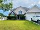 Charming two-story home with manicured lawn and attached garage, perfect for suburban living at 15 Emerson Trl, Covington, GA 30016