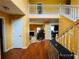 Inviting foyer with hardwood floors, staircase, and views of the living room with fireplace at 15 Emerson Trl, Covington, GA 30016
