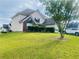 Lovely home with a sprawling green lawn and mature trees, great for outdoor activities at 15 Emerson Trl, Covington, GA 30016