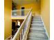 Carpeted staircase leading to the second floor, with a view of the downstairs living area at 15 Emerson Trl, Covington, GA 30016