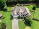 A beautiful aerial view of this landscaped property with a manicured lawn and mature trees at 1539 School House Run, Dacula, GA 30019
