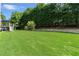Large, inviting backyard featuring a well-kept lawn and the home's exterior with a relaxing deck at 1539 School House Run, Dacula, GA 30019