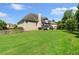 Expansive backyard with well-maintained lawn and view of the home's exterior and deck at 1539 School House Run, Dacula, GA 30019