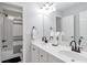 Bright bathroom with double sinks, modern faucets, and a tub with a subway tile surround at 1539 School House Run, Dacula, GA 30019